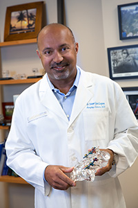 Dr. Jantana posing for photo with anatomy model